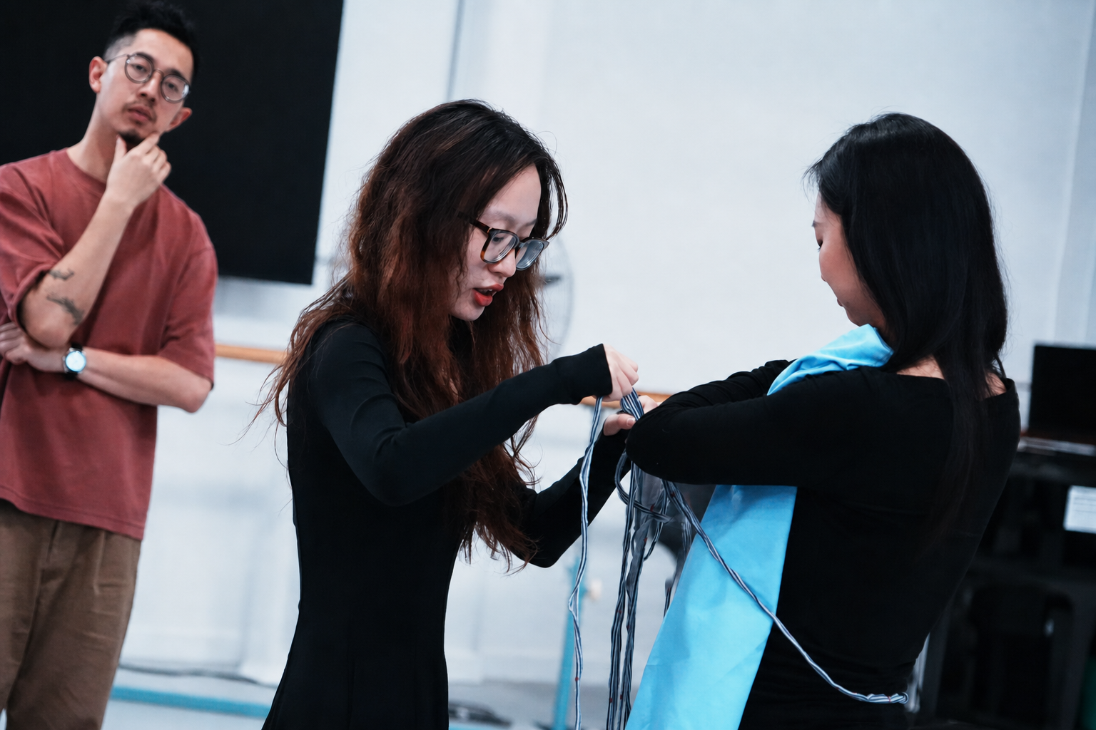 Participants collaborating with fabric and thread in an applied theatre exercise