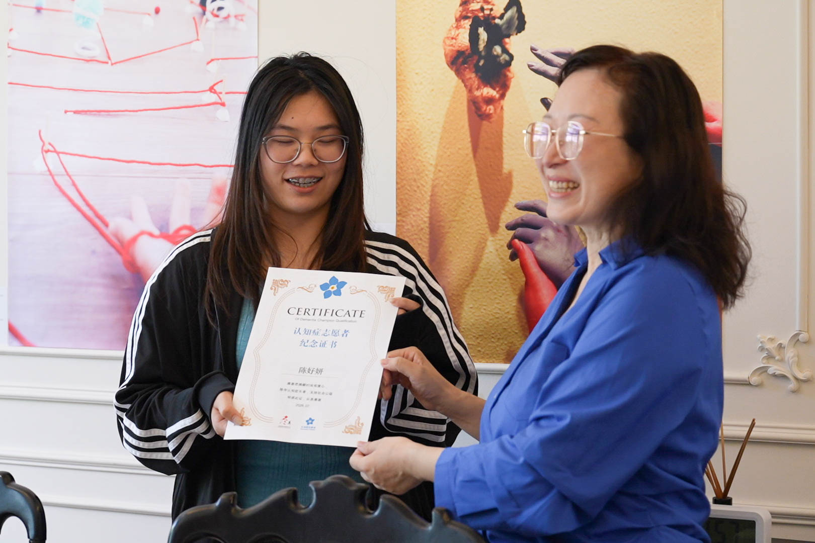 A participant receiving a certificate after completing a creative programme